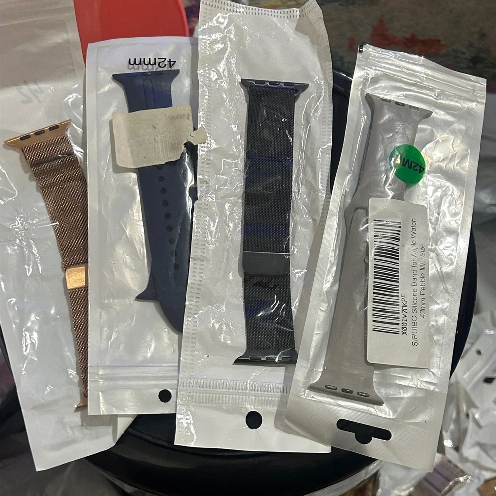 Assorted apple Watch Bands in Gold, Blue, and Gray & black